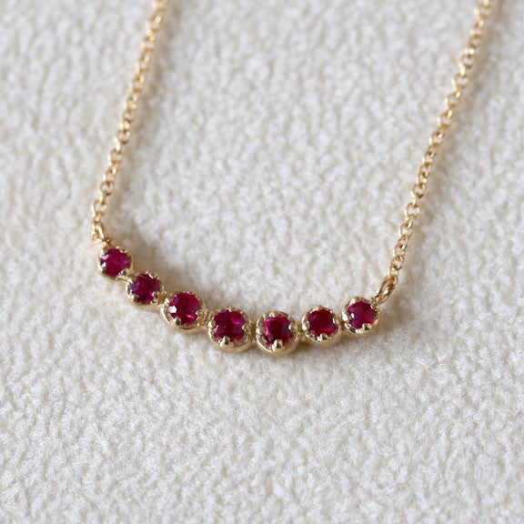 Curved 7 bezel ruby necklace